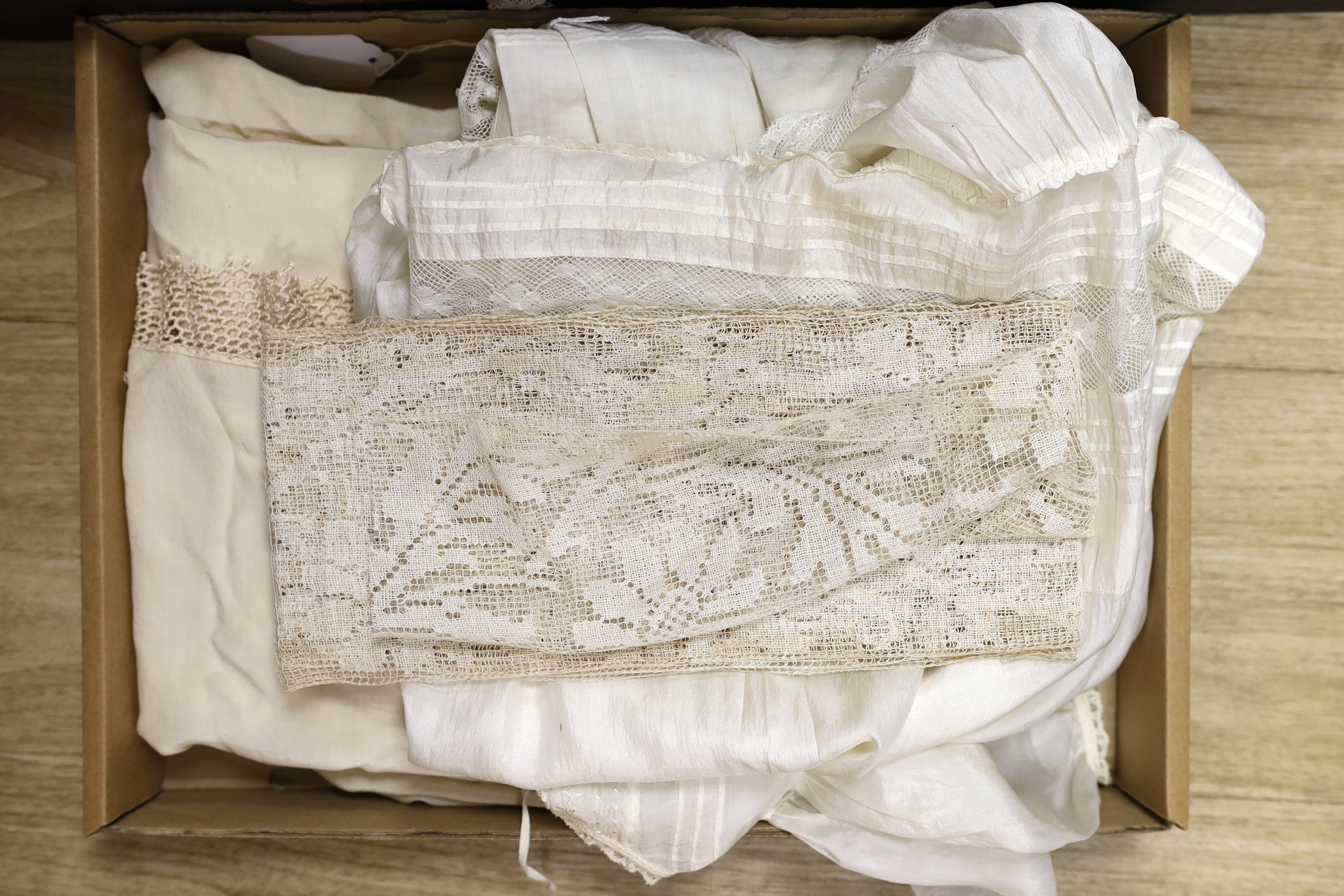 A quantity of mixed machine and some handmade lace including Irish crochet, together with a white work petticoat, silk christening gown and a silk shawl